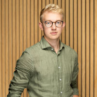Headshot of man in green shirt