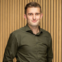 Headshot of man in dark green shirt